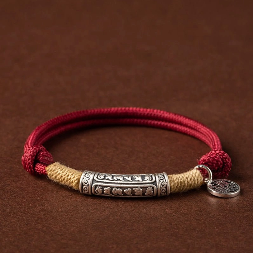 Tibetan handmade om mani padme hum sterling silver bracelet with red cord and fu character charm on dark background