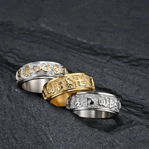 Collection of three sacred mantra spinner rings in different finishes displaying carved Sanskrit and Tibetan Buddhist designs