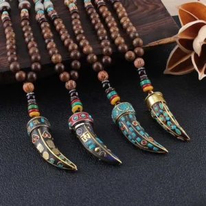 Tibetan Om Mani Padme Hum wenge wood necklace with horn pendant flat lay top view, featuring dark wooden beads and ornate metal pendant with Tibetan script