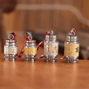 Set of four Tibetan prayer wheel amulets with varying Sanskrit mantras and titanium steel construction