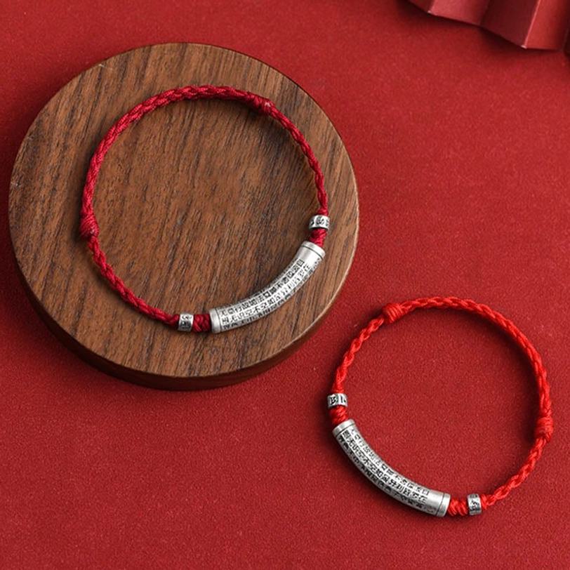 Tibetan om mantra silver bracelet displaying handmade quality and braided rope construction for spiritual wear