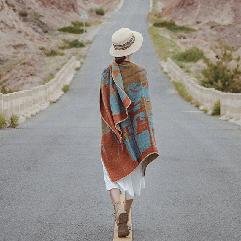Tibetan wool cape shawl full back view with traditional geometric pattern and straw hat