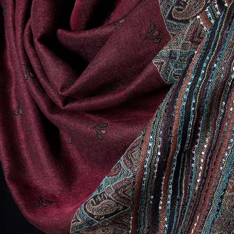 Tibetan paisley geometric tassel shawl detail showing intricate woven patterns, stripe designs, and traditional craftsmanship with visible tassels