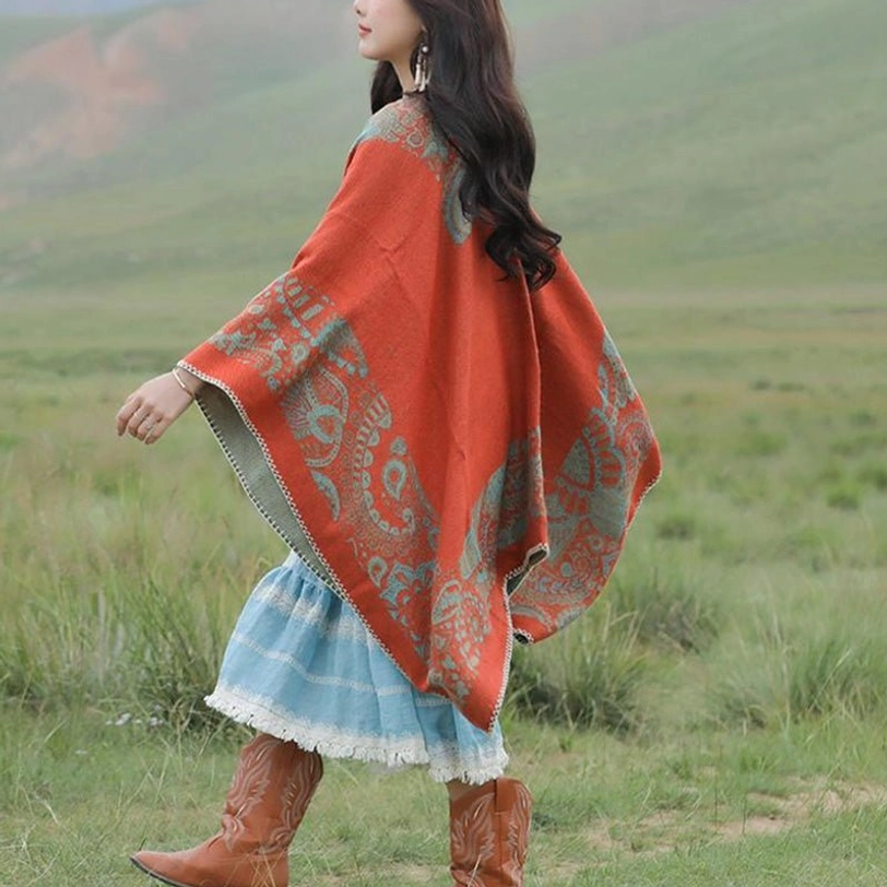 Blue Brown color variant of Tibetan paisley poncho shawl displayed in outdoor natural light