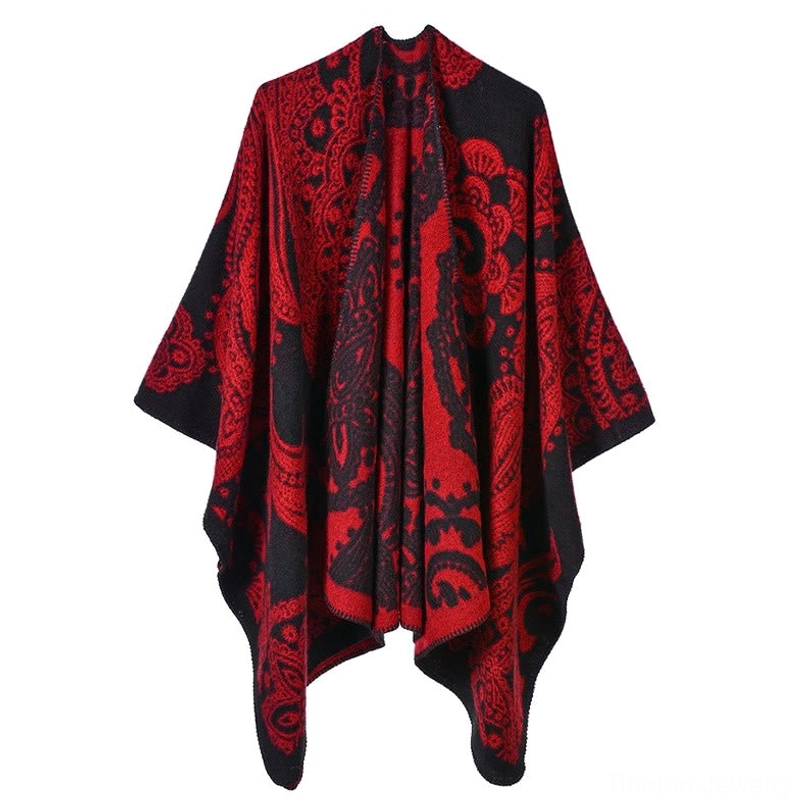 Tibetan paisley poncho shawl in crimson red, detail view showing handwoven jacquard pattern and artisan craftsmanship