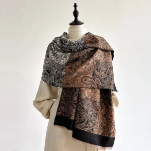 Black Tibetan paisley vine scarf on dress form, showcasing intricate ethnic pattern and soft woven texture with frayed hem details