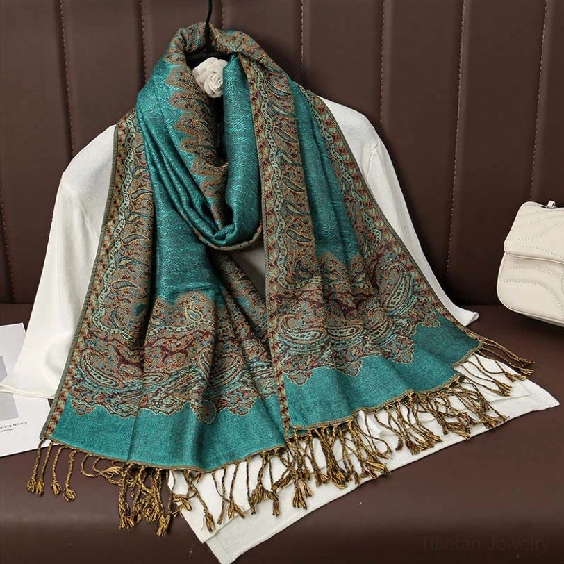 Dark cyan tibetan paisley tassel scarf full view displaying rich jacquard weave and tasseled fringe borders