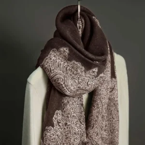 Deep brown paisley tassel scarf hanging close-up showing soft woven jacquard fabric texture and tassel details