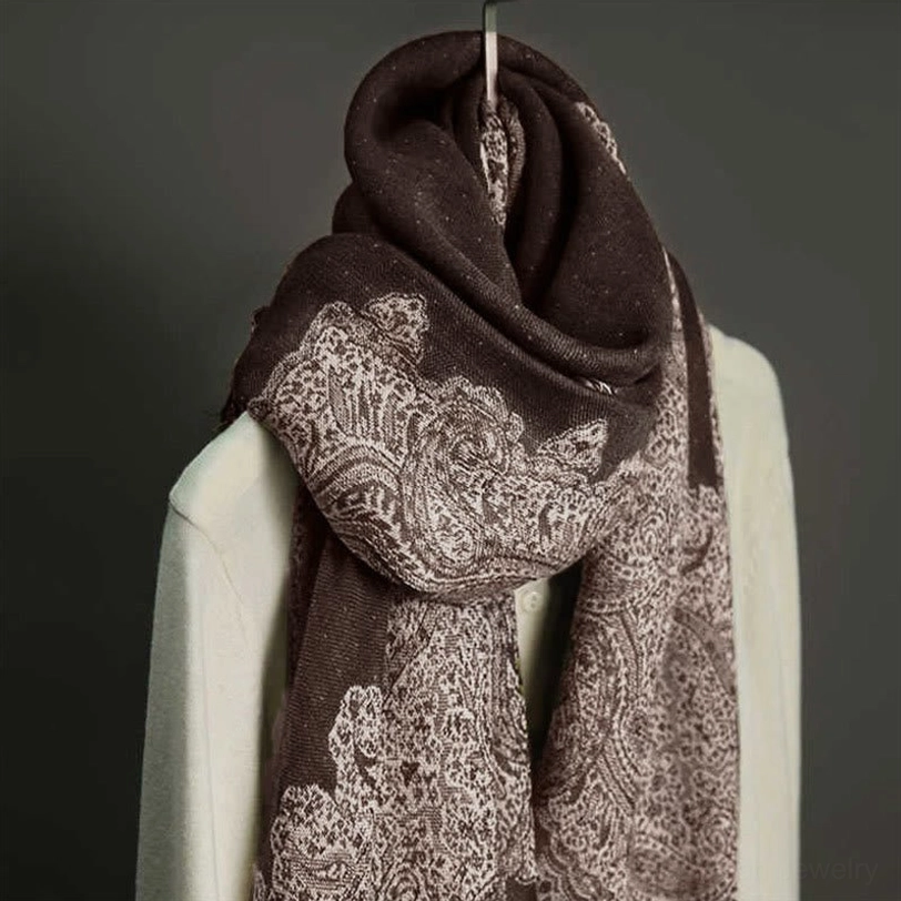 Deep brown paisley tassel scarf hanging close-up showing soft woven jacquard fabric texture and tassel details