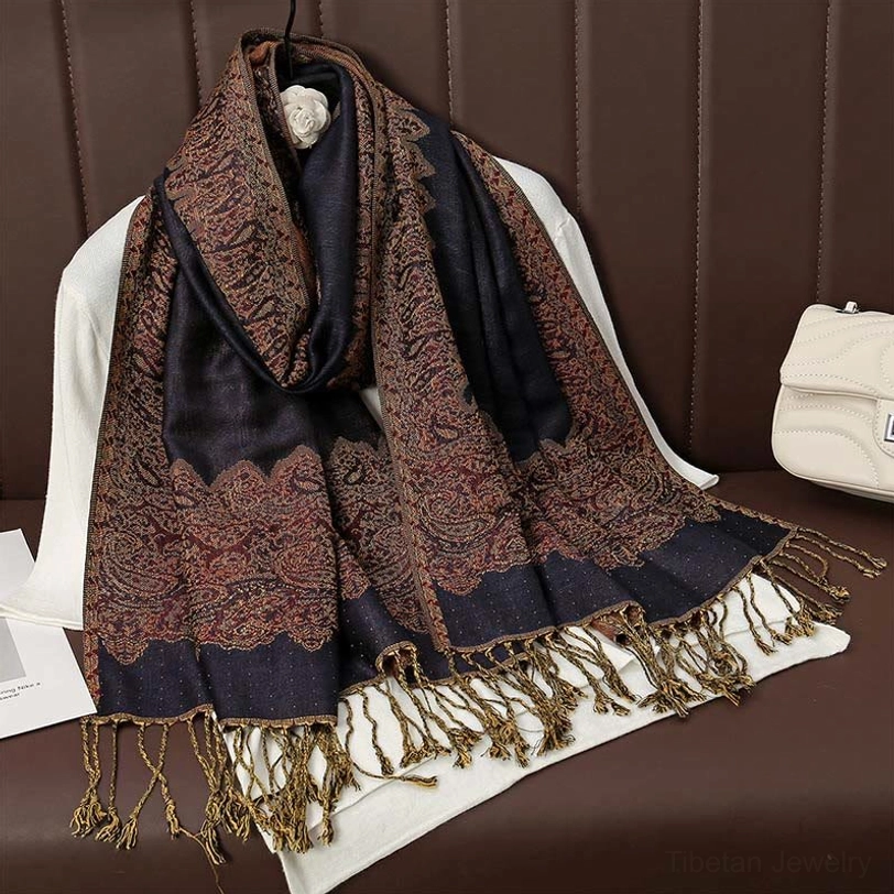 Navy blue and dark brown two-tone paisley tassel scarf with bordered paisley print and brown tassel trims on display