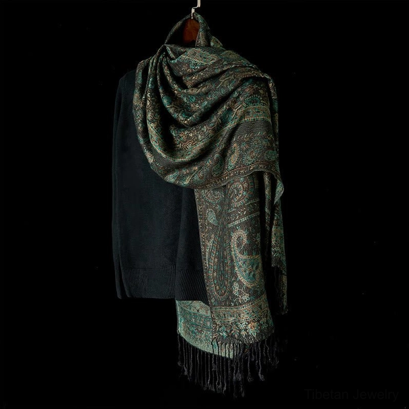 Tibetan geometric paisley shawl back view, hanging display showing black tassel fringe and woven pattern