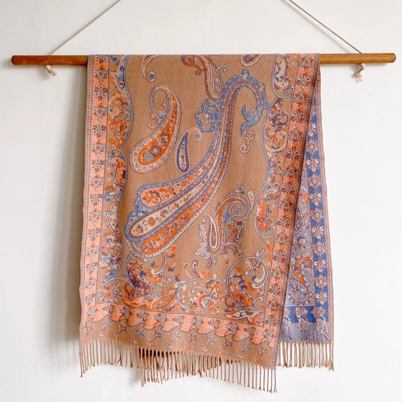 Beige Tibetan tassel shawl hanging full-length display showing complete pattern coverage and fringe hem