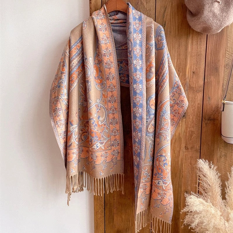 Beige Tibetan paisley tassel shawl on model at outdoor mountain setting showing light tone versatility