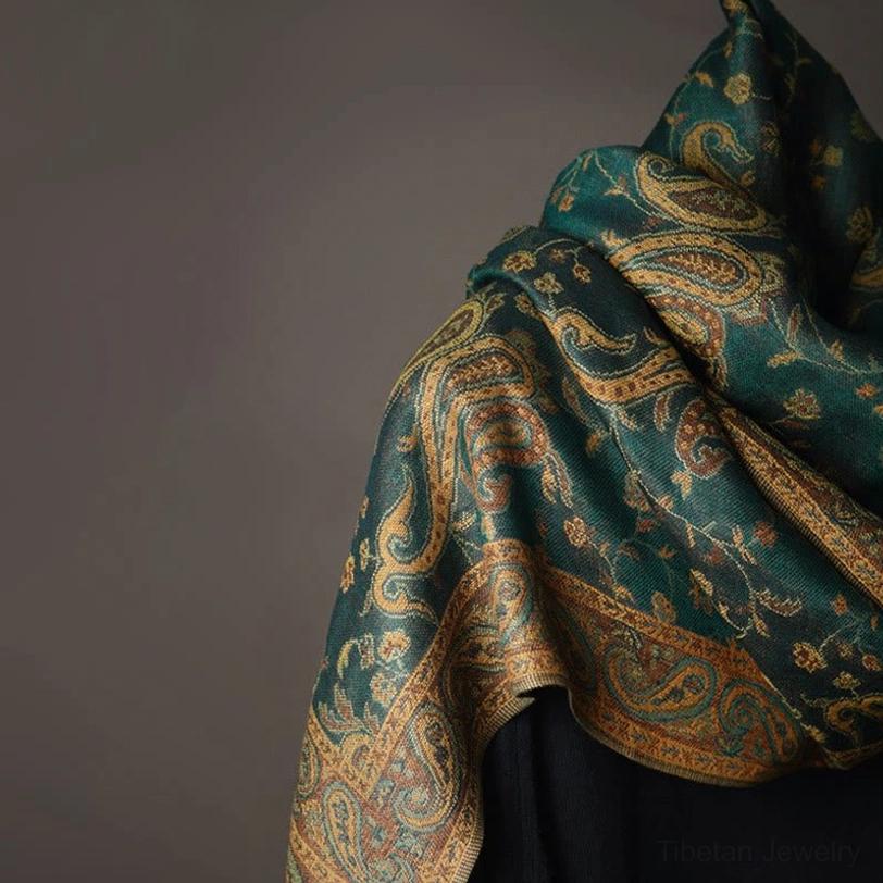 Close-up view of tibetan paisley shawl border trim and detailed vintage cashew flower print on dark fabric