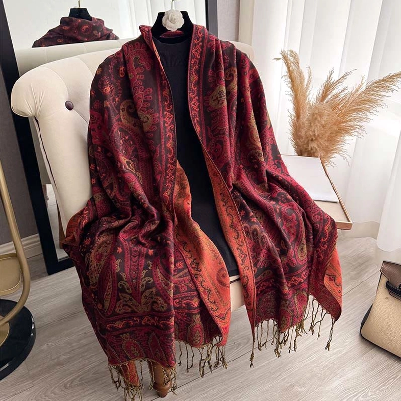 Burgundy and orange paisley shawl on dress form with contrast fringe trim detail