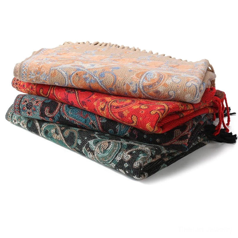 Tibetan paisley tassel shawl lifestyle image showing multiple color variants arranged artfully