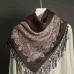 Dark brown and beige paisley jacquard tassel shawl displayed flat from overhead showing full jacquard pattern and fringed edges