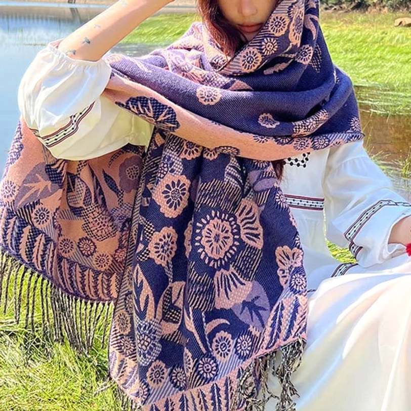 Tibetan ethnic paisley shawl in dark jewel tone worn during outdoor adventure demonstrating durability and travel versatility