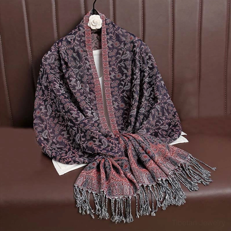 Tibetan paisley tassel shawl in dark magenta jewel tone color highlighting richness of handwoven dye and Tibetan color tradition