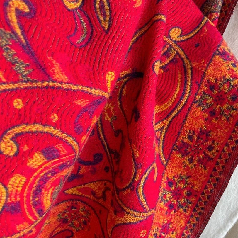 Dark Sea Green Tibetan paisley tassel shawl displayed full-length showing jewel-tone color and traditional motifs