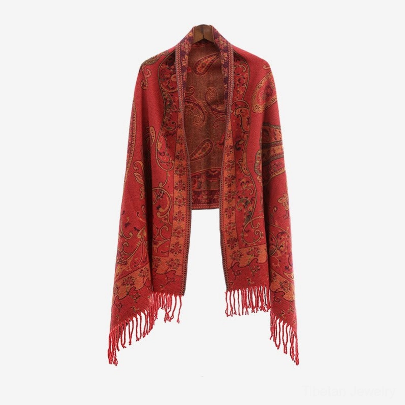 Dark Sea Green Tibetan paisley shawl side profile on model at outdoor mountain location showing fit and texture