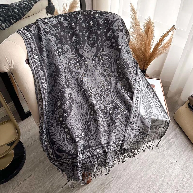 Dim gray and silver Tibetan paisley tassel shawl overhead flat lay showing reversible design