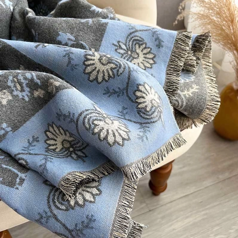 Tibetan paisley shawl close-up showing floral texture detail and hand-fringed raw edges