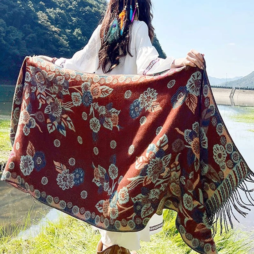 Tibetan paisley shawl with emerald green tones and intricate ethnic patterns worn in natural outdoor woodland setting