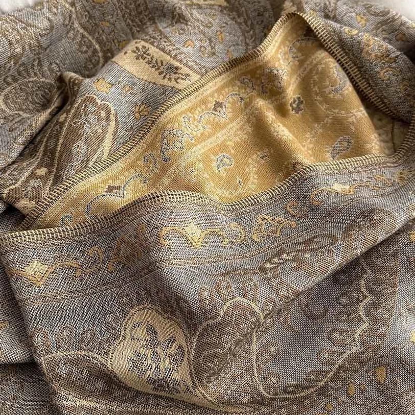 Tibetan handwoven paisley shawl styled as evening wrap on model