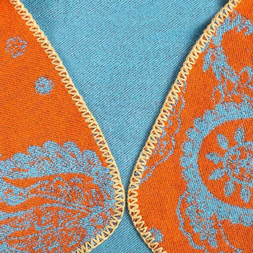 Tibetan paisley shawl close-up macro view showing jacquard weave texture and stitching detail