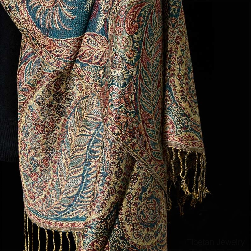 Flat lay display of multicolor vintage paisley Tibetan shawl with detailed jacquard pattern and fringed edges