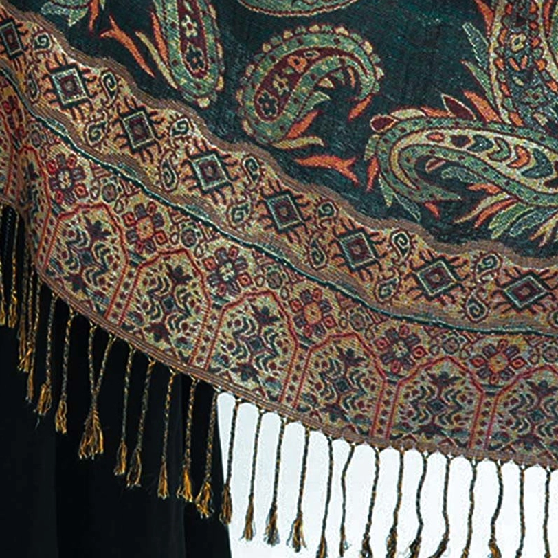 Tibetan paisley shawl hem detail showing hand-twisted long tassel fringe and warm brown red patterned border