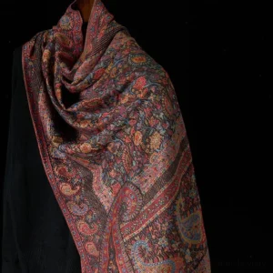Tibetan paisley tassel shawl in warm brown tones, front three-quarter view showcasing intricate jacquard woven pattern and decorative tassels