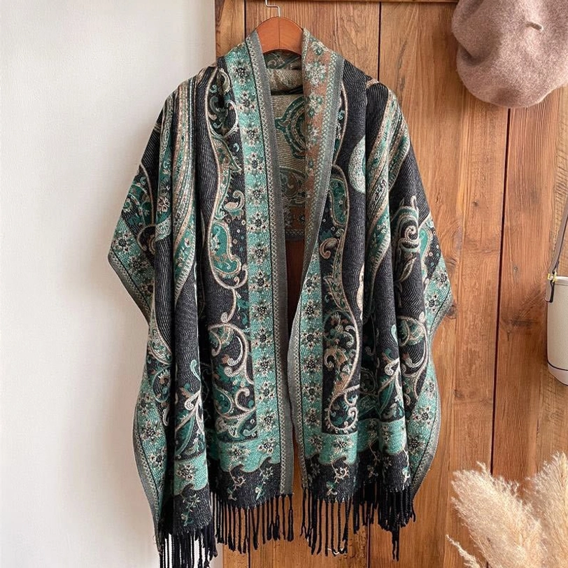 Full hanging flat display of Tibetan paisley tassel shawl on wooden background, showing complete pattern and double-sided fringe