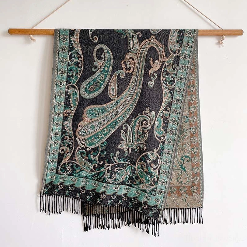 Dark gray Tibetan paisley thermal shawl with teal and black print, hung flat showing full dimensions and black fringe