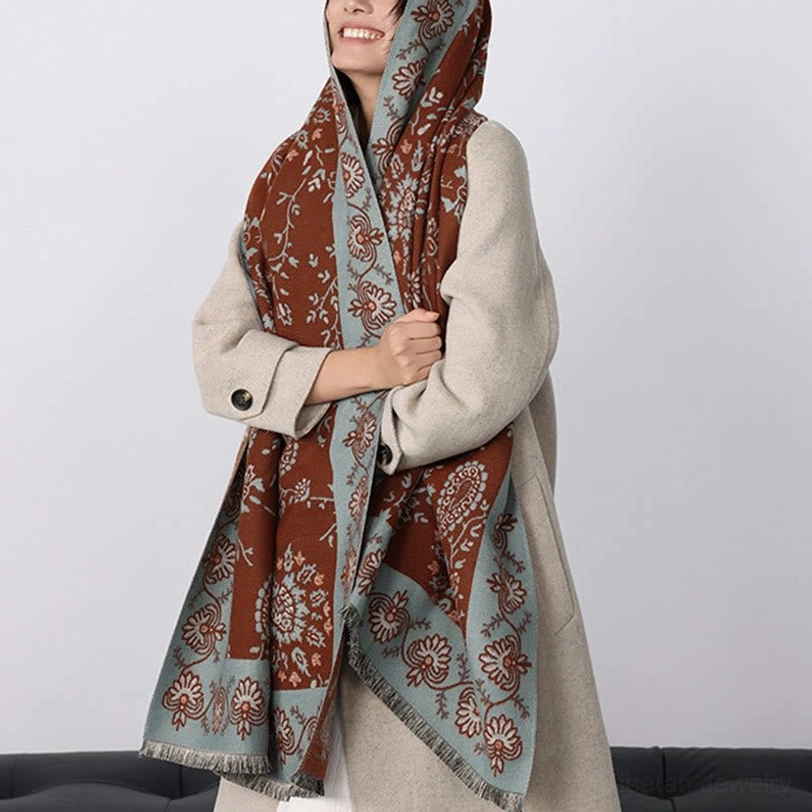 Tibetan paisley shawl worn over beige overcoat with hooded draped style on model