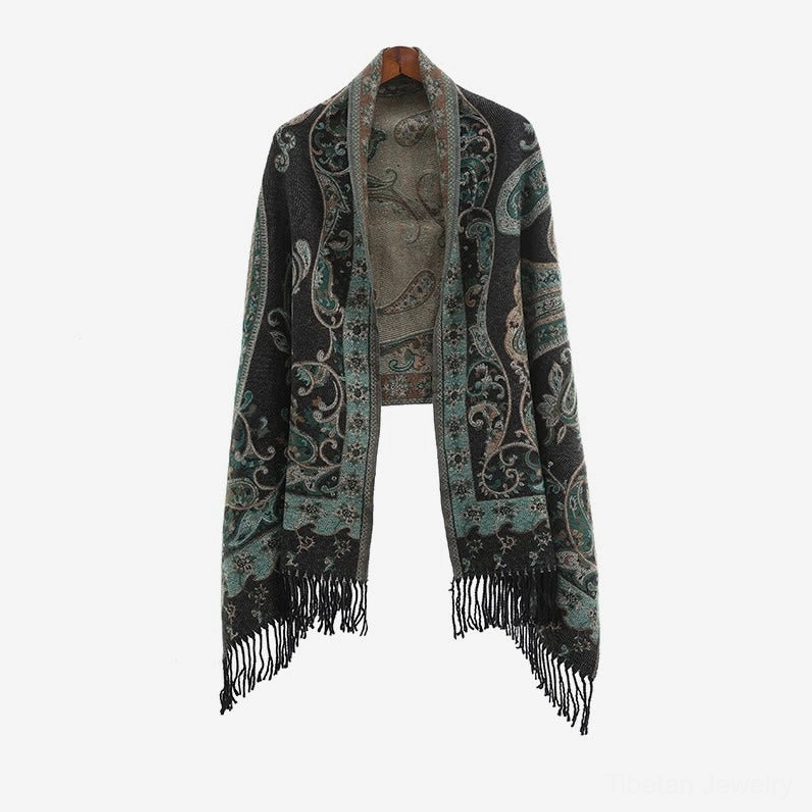 Tibetan paisley tassel shawl on mannequin in open front wrap design showing dark base with teal paisley and fringe ends