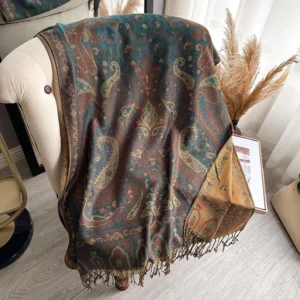 Overhead view of reversible Tibetan paisley shawl with contrast border and fringe tassel hem