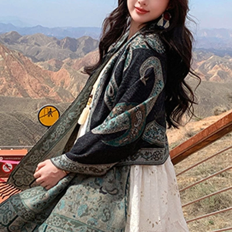 Tibetan paisley tassel shawl worn as oversized wrap on side model at mountain vista, showing soft texture and fit