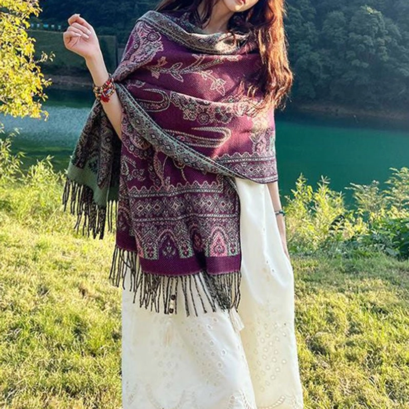 Purple base Tibetan botanical shawl with paisley motifs and tassel trim at sunset lakeside