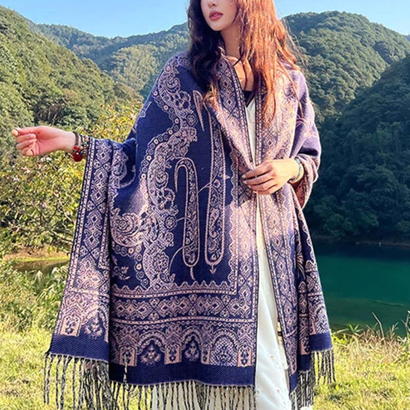 Tibetan ethnic paisley shawl draped over shoulders showing elegant silhouette and sophisticated color palette for fashion styling