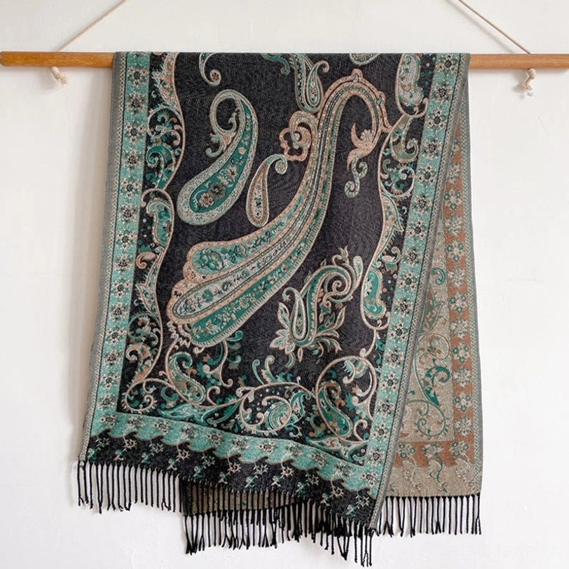 Tibetan paisley tassel shawl hung flat in studio showing full front paisley print, reversible hem patterns, and long fringe