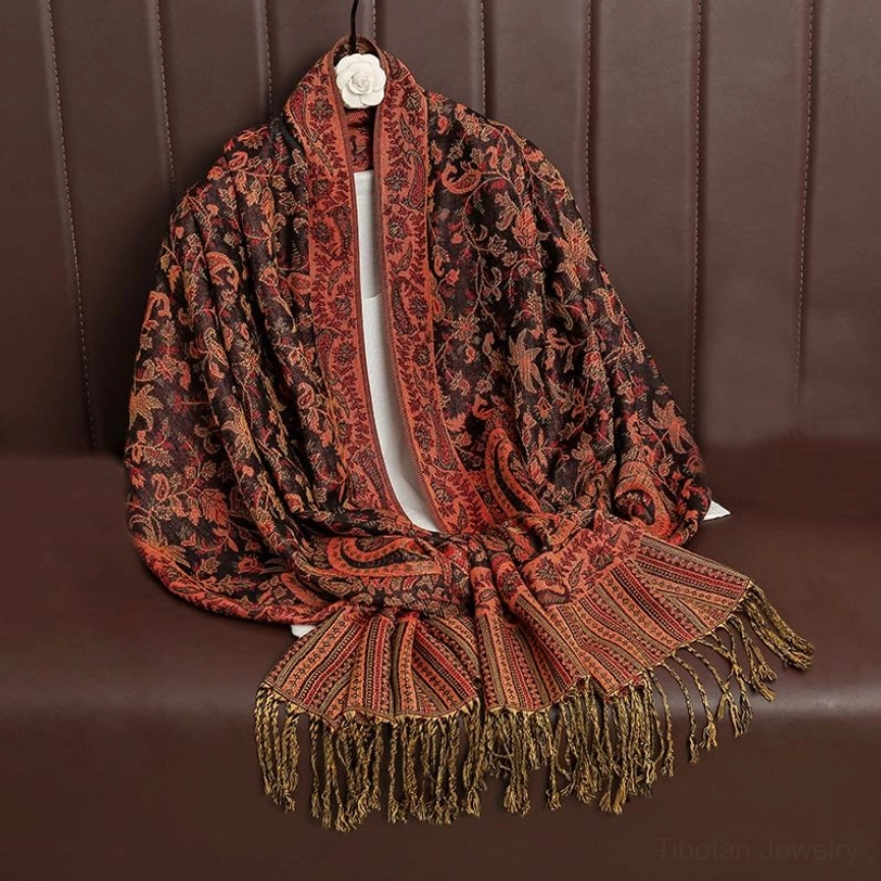 Tibetan ethnic paisley shawl tassel hem detail close-up showing handcrafted jacquard weaving and fringe