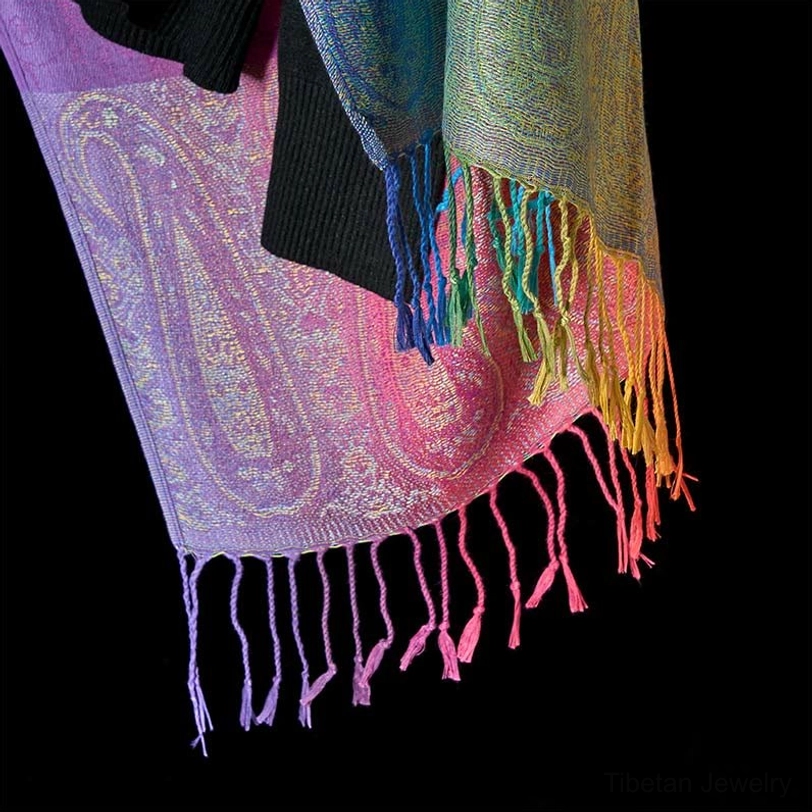 Tibetan paisley tassel shawl hem close-up - multi-color gradient tassels and jacquard fabric detail