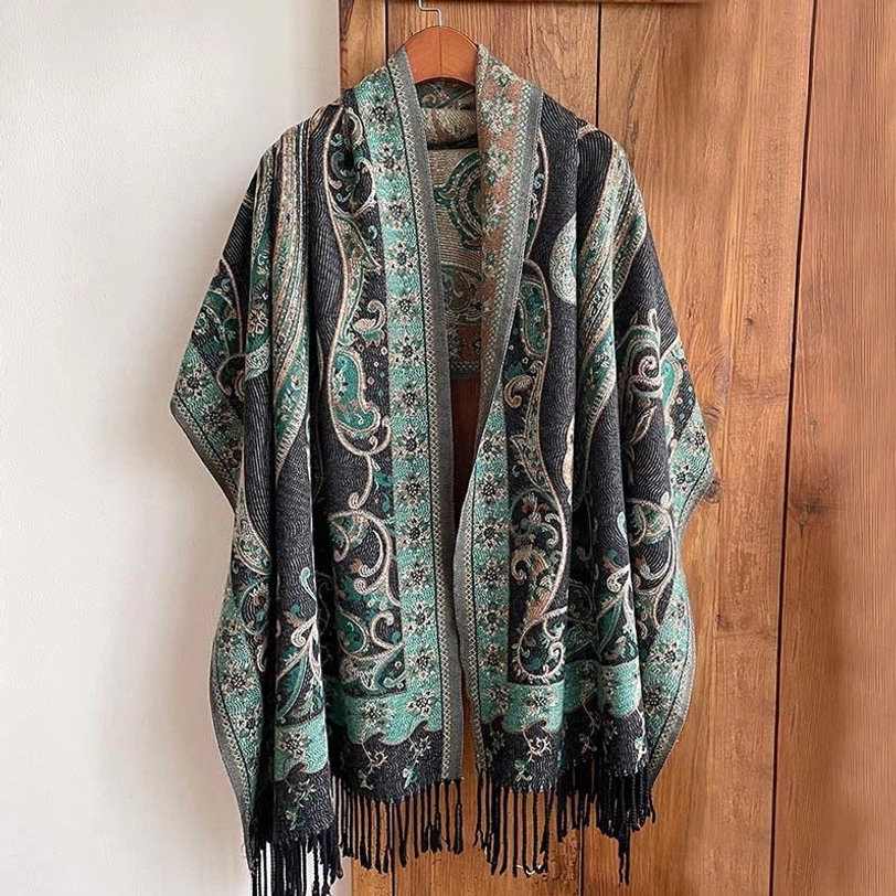 Teal and dark gray Tibetan paisley tassel shawl with black tassels, front view on wooden hanger
