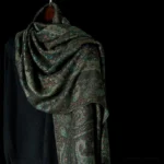 Tibetan paisley tassel shawl in rich teal, draped close-up showing intricate geometric woven pattern and detail