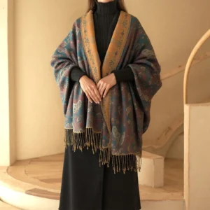Woman wearing teal and mustard Tibetan paisley tassel shawl with contrast collar, full front view