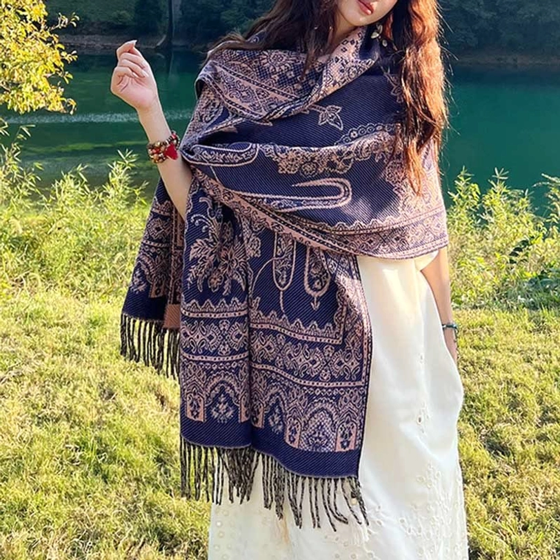 Tibetan ethnic paisley shawl worn as travel blanket demonstrating versatile styling and comfortable draping for multiple uses