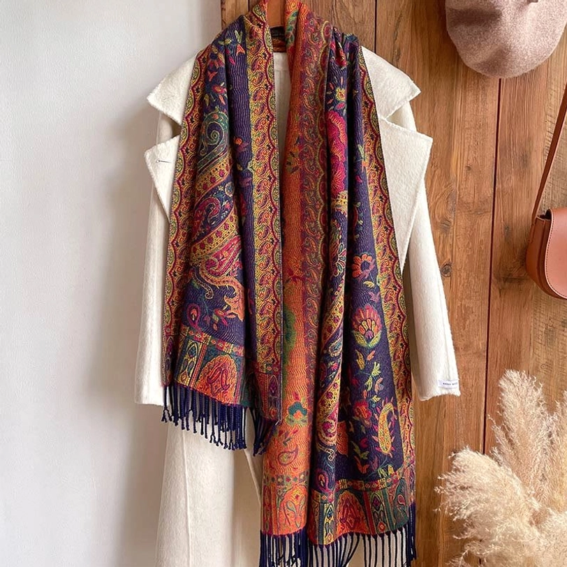 Hanging paisley tassel shawl displayed vertically on coat rack, full view showing bohemian ethnic print design