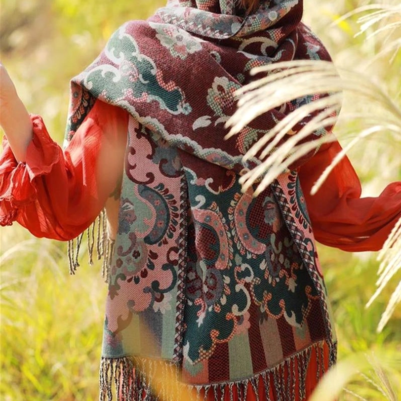 Tibetan vine leaf shawl side back view featuring bold paisley motifs and detailed jacquard hemline in sunlight